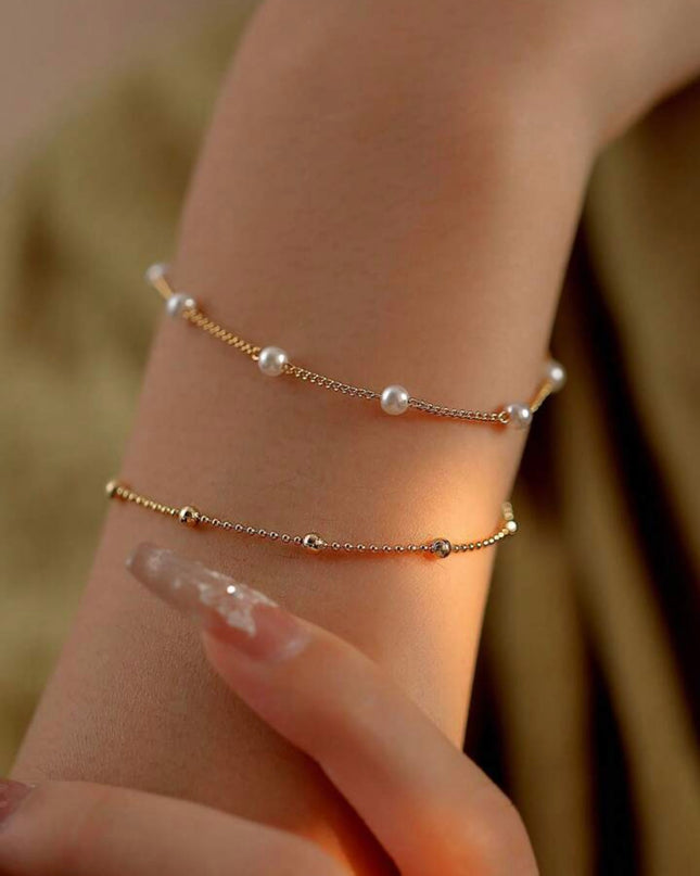 Set de 2 Pulseras Doradas con Piedras Blancas