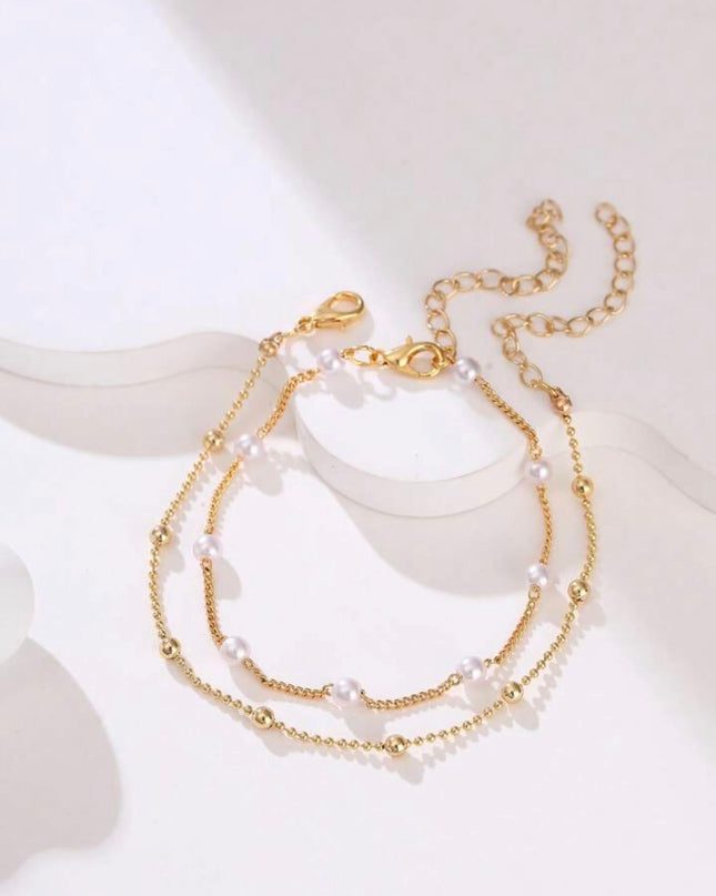 Set de 2 Pulseras Doradas con Piedras Blancas