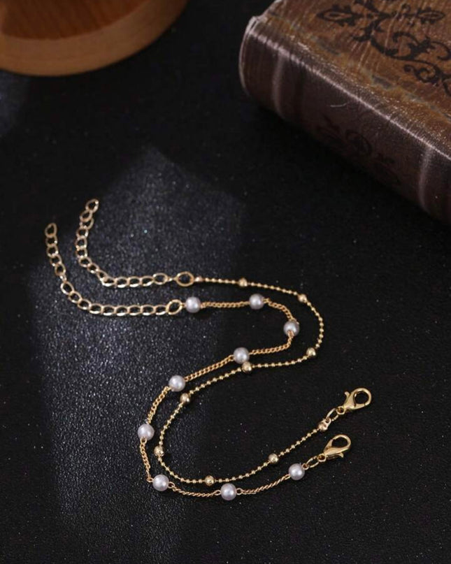 Set de 2 Pulseras Doradas con Piedras Blancas