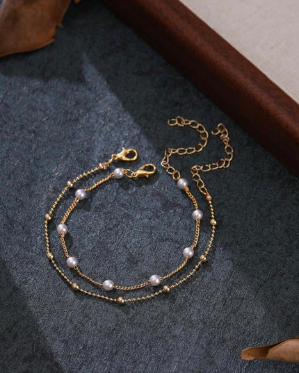 Set de 2 Pulseras Doradas con Piedras Blancas