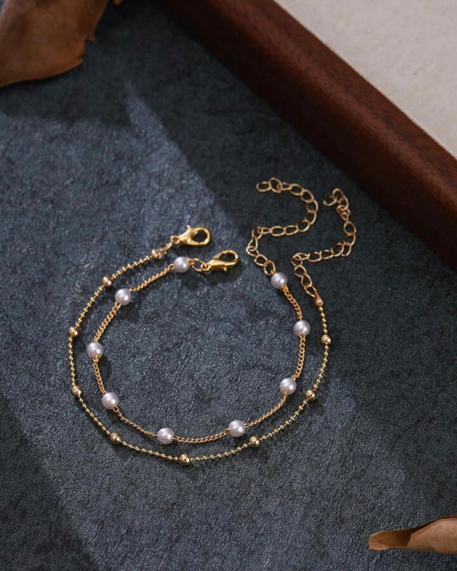 Set de 2 Pulseras Doradas con Piedras Blancas