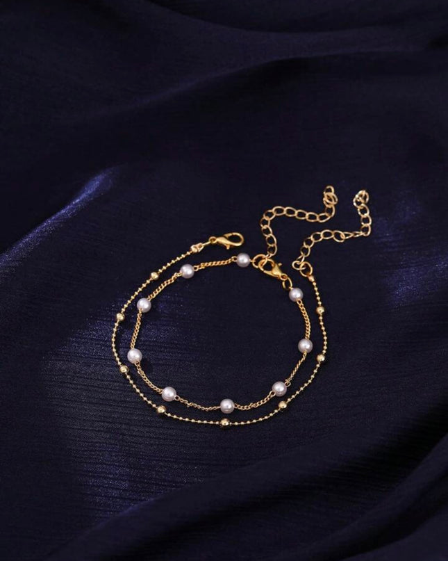 Set de 2 Pulseras Doradas con Piedras Blancas