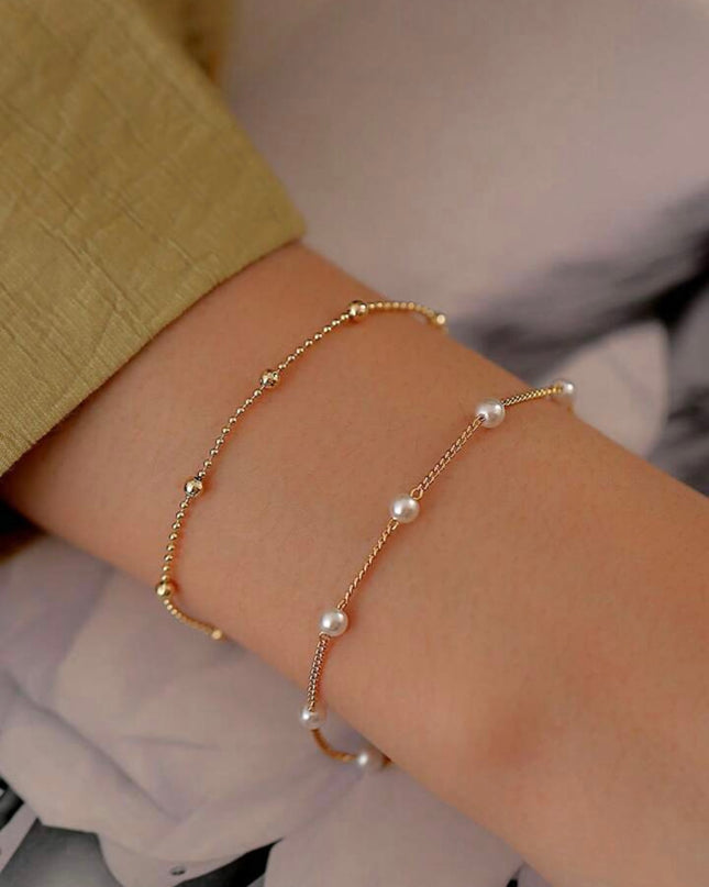 Set de 2 Pulseras Doradas con Piedras Blancas