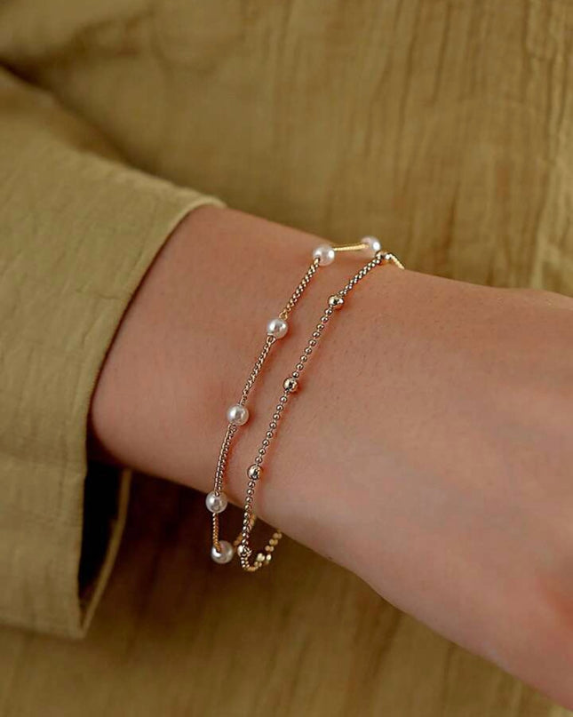 Set de 2 Pulseras Doradas con Piedras Blancas