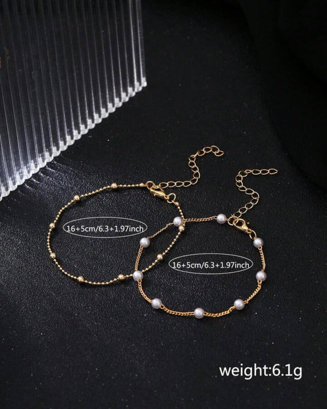 Set de 2 Pulseras Doradas con Piedras Blancas